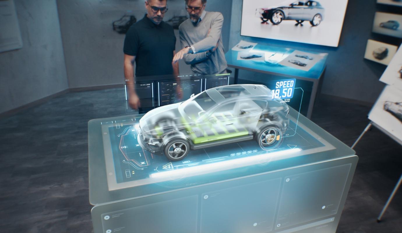 Two development engineers using an advanced, holographic augmented reality desk.